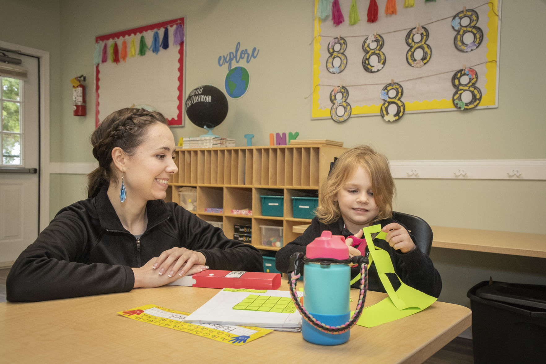 Oak Grove Academy teacher guides student during arts & crafts activity
